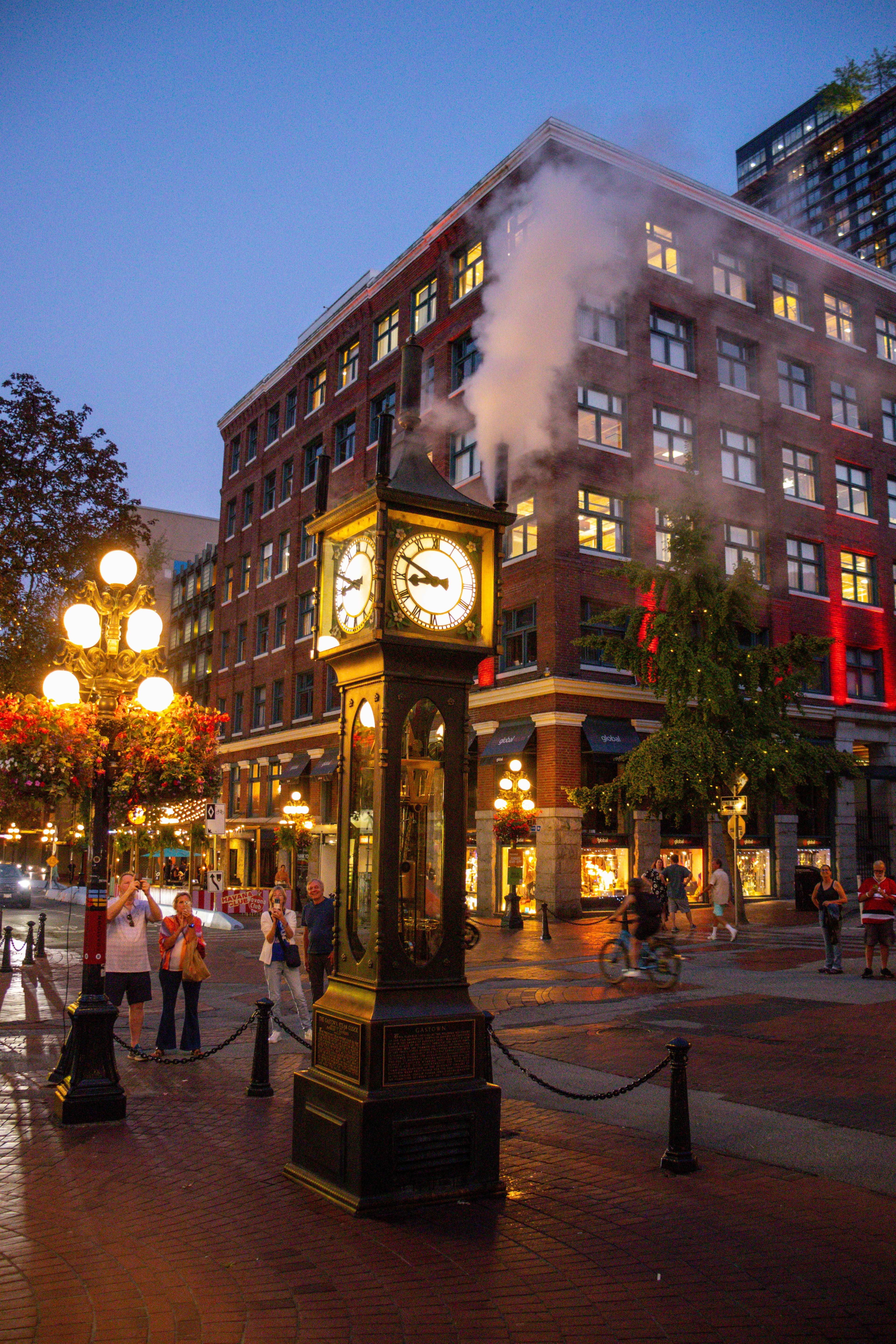 Gastown steam powered clock at dusk with shops surrounding