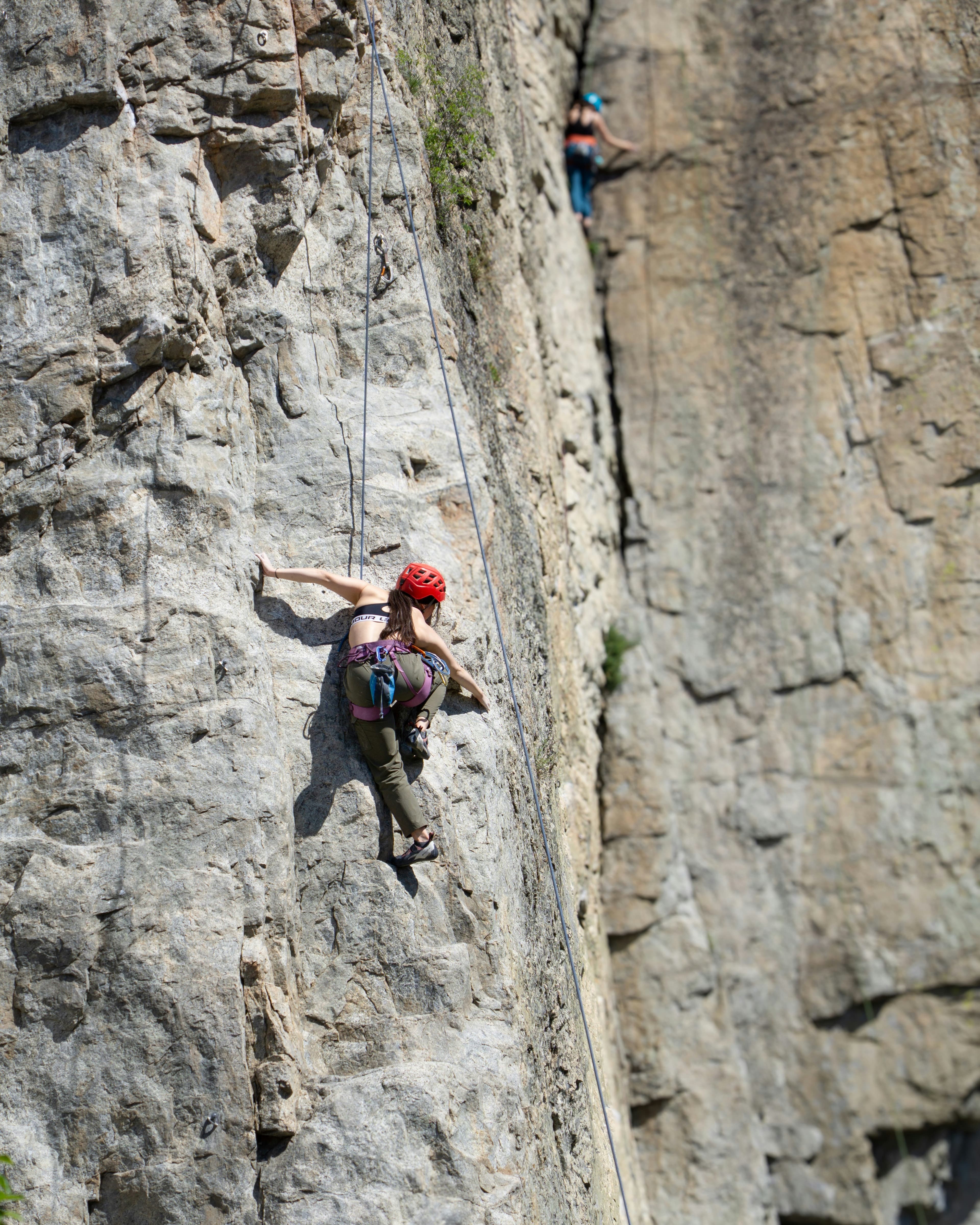 A person in red helmet rock climbing
